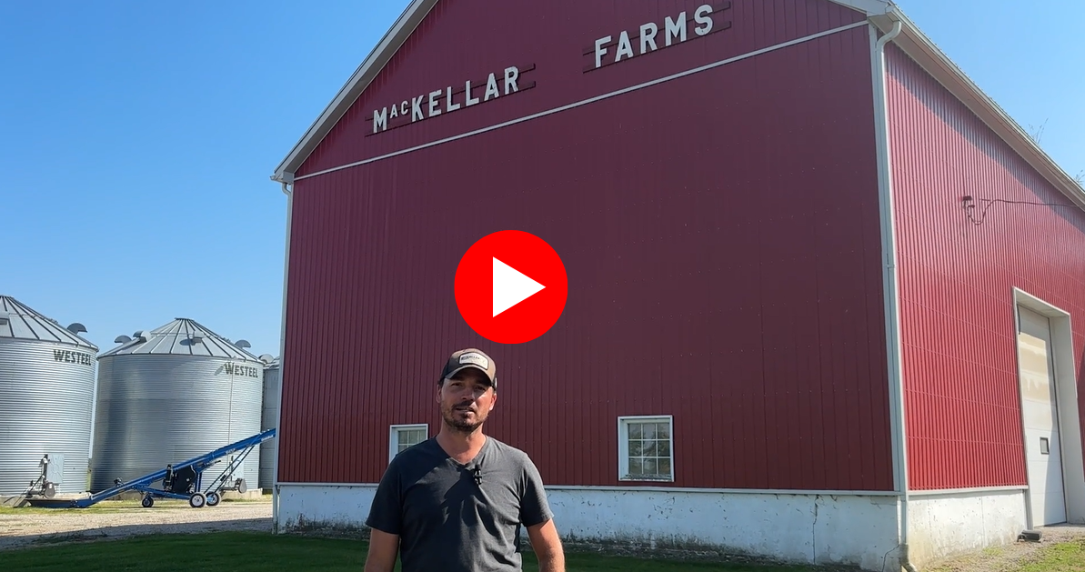 Man-standing-red-barn