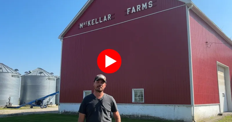 Man-standing-red-barn